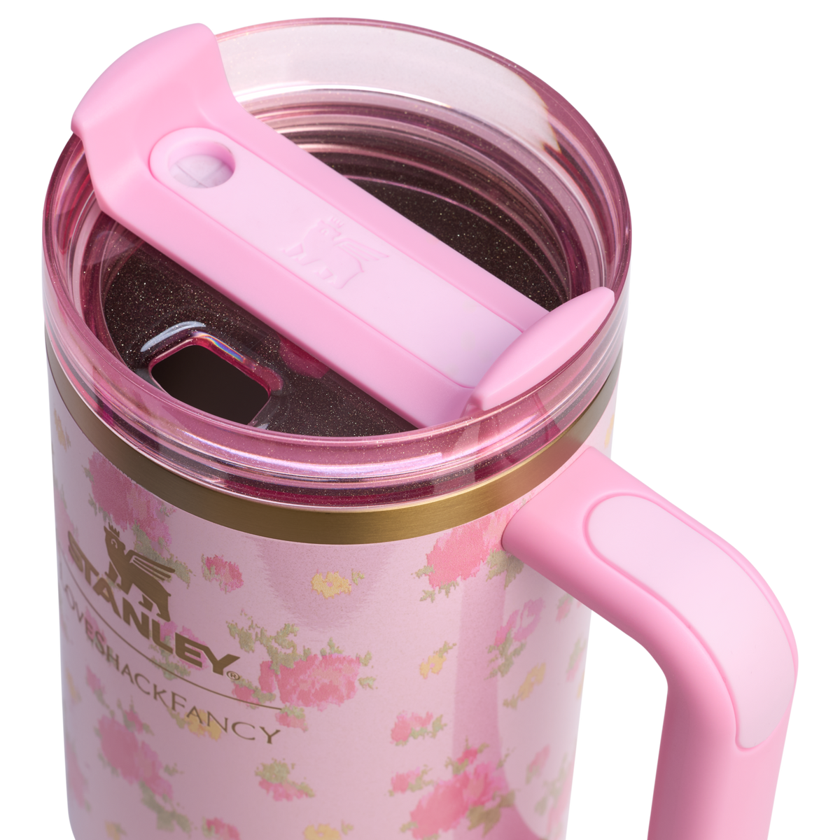 Pink Stanley travel mug with floral design and pink lid, featuring Stanley logo and handle