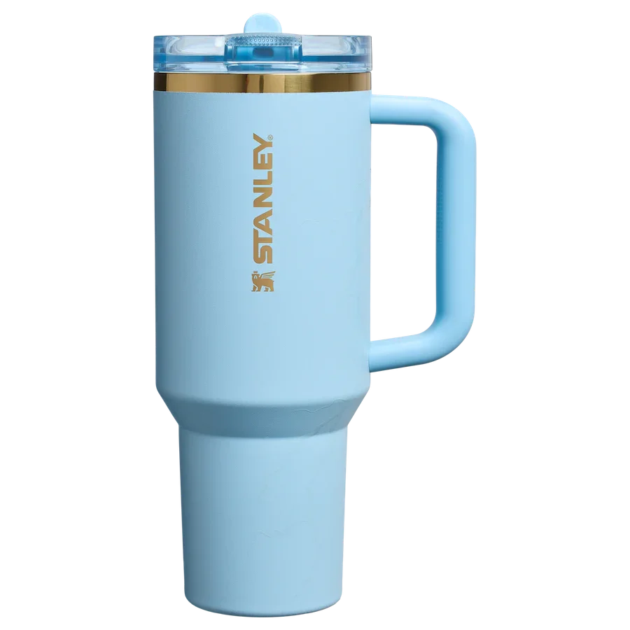 Light blue Stanley insulated travel mug with clear lid and gold logo, ergonomic handle