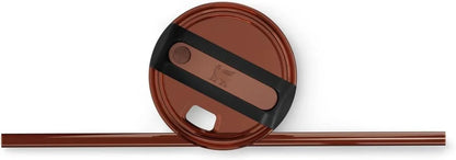 Brown reusable coffee cup lid with black silicone grip and matching brown straw on white background