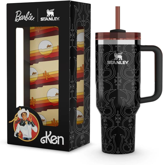 Stanley black travel mug with white stitched pattern and pink lid next to Barbie Ken collaboration box