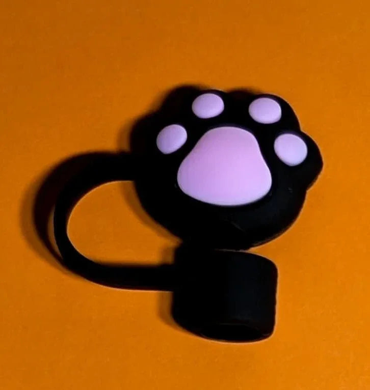 black silicone ring with pink cat paw design on orange background