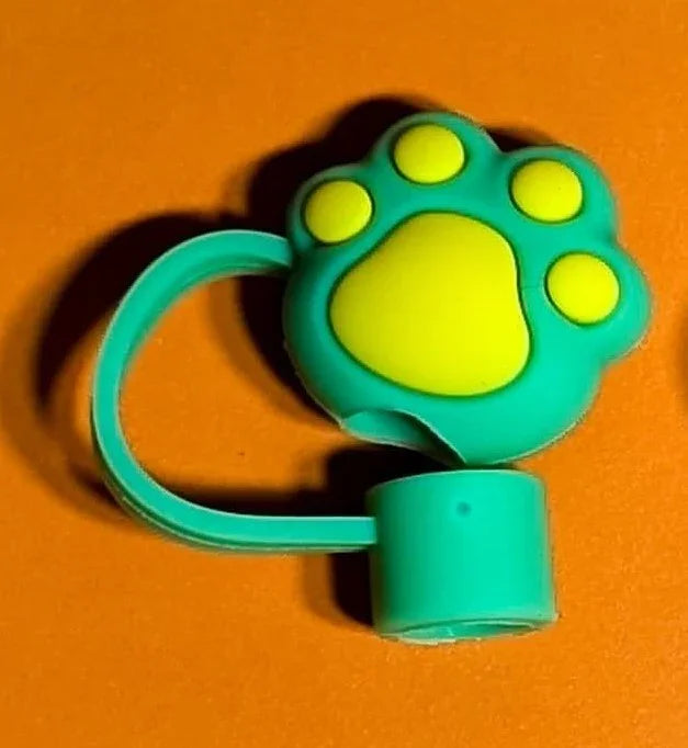 green and yellow cat paw-shaped keychain accessory on orange background
