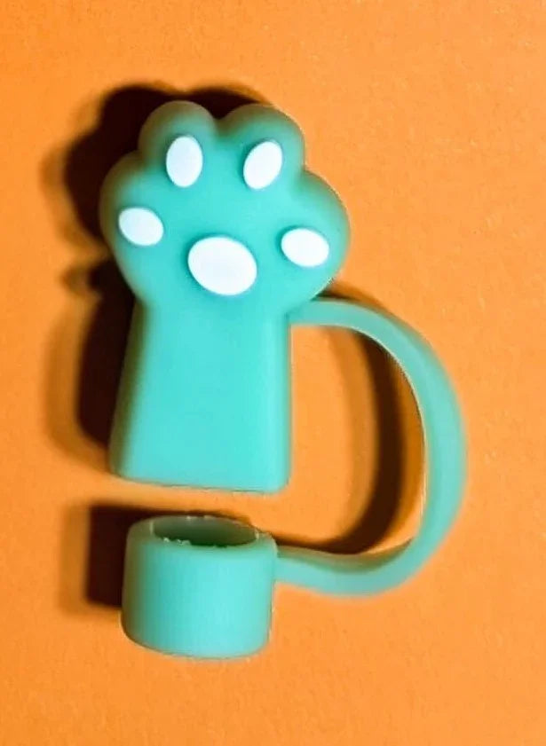 Blue cat paw-shaped silicone hand sanitizer holder on orange background