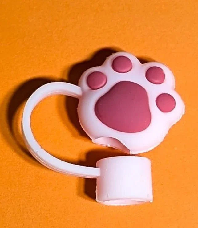White and pink cat paw-shaped silicone ring accessory on orange background