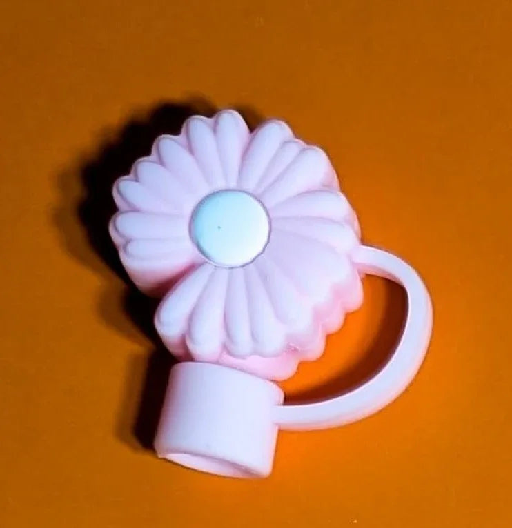 Pink sunflower-shaped silicone bottle holder on orange background