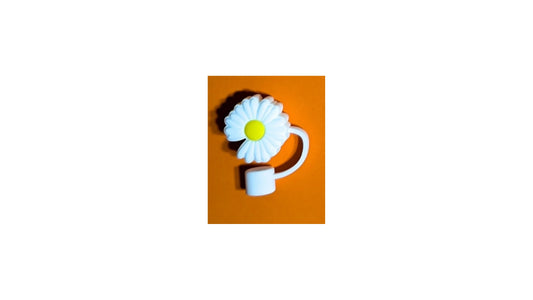 White daisy-shaped silicone ring with yellow center on orange background