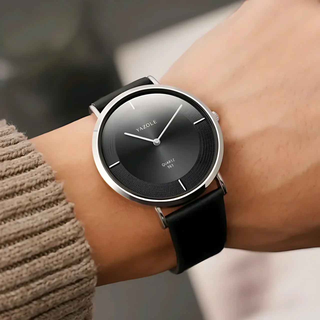 Yazole minimalist black dial quartz wristwatch with silver case and black leather strap on wrist