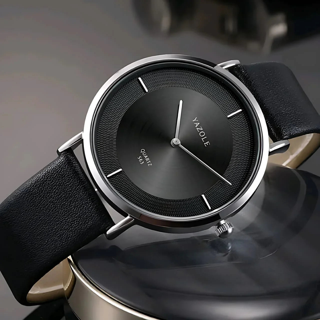Close-up of Yazole black quartz wristwatch with leather strap and silver case