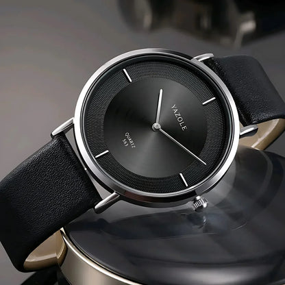 Close-up of Yazole black quartz wristwatch with leather strap and silver case