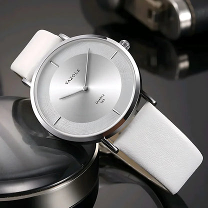 Yazole minimalist silver quartz wristwatch with white leather strap on reflective surface
