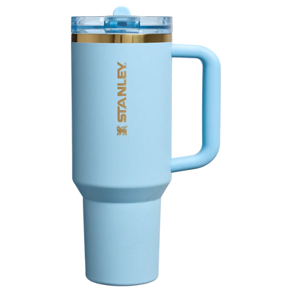 Light blue Stanley insulated travel mug with clear lid and gold logo, ergonomic handle