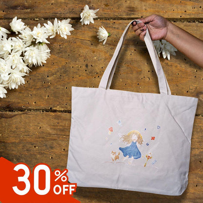 Beige tote bag with a cute girl and dog illustration, held by hand on wooden surface with white flowers, 30% off