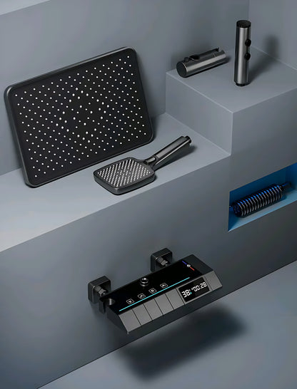 Modern digital shower control panel with temperature display and black showerhead and accessories on gray platform