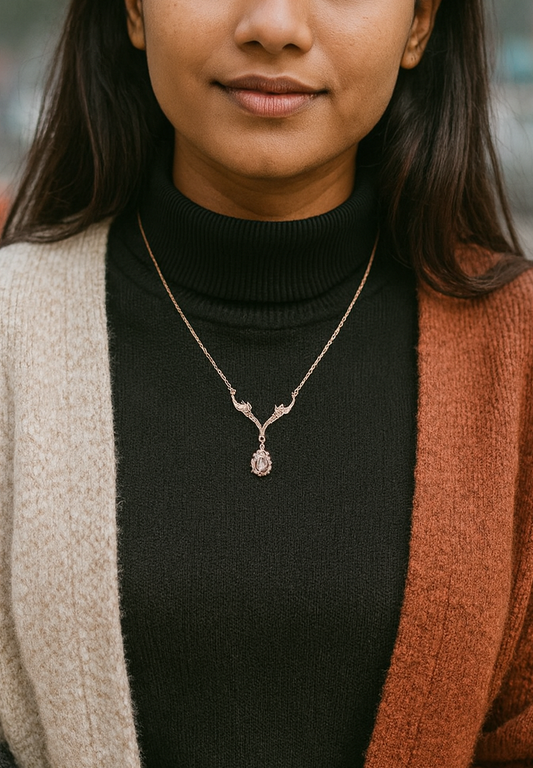 Close-up of woman wearing black turtleneck and color-block cardigan with intricate pendant necklace