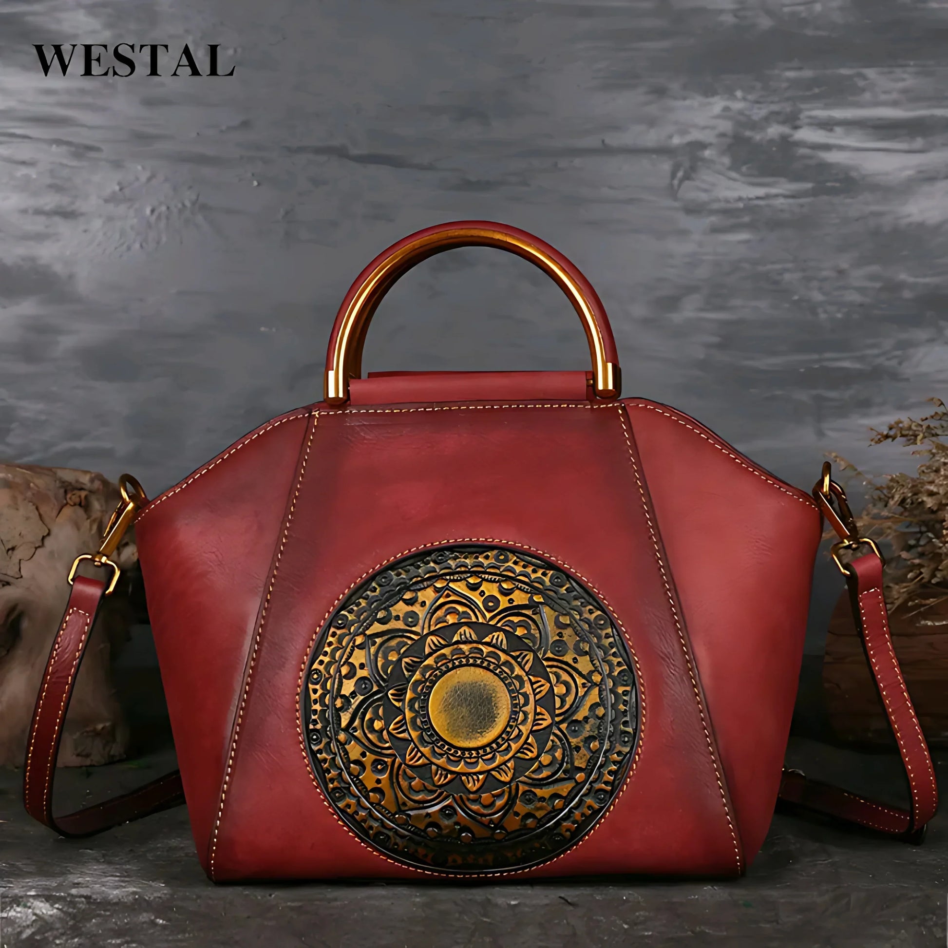 Red leather handbag with embossed floral mandala design and gold metal handle by Westal